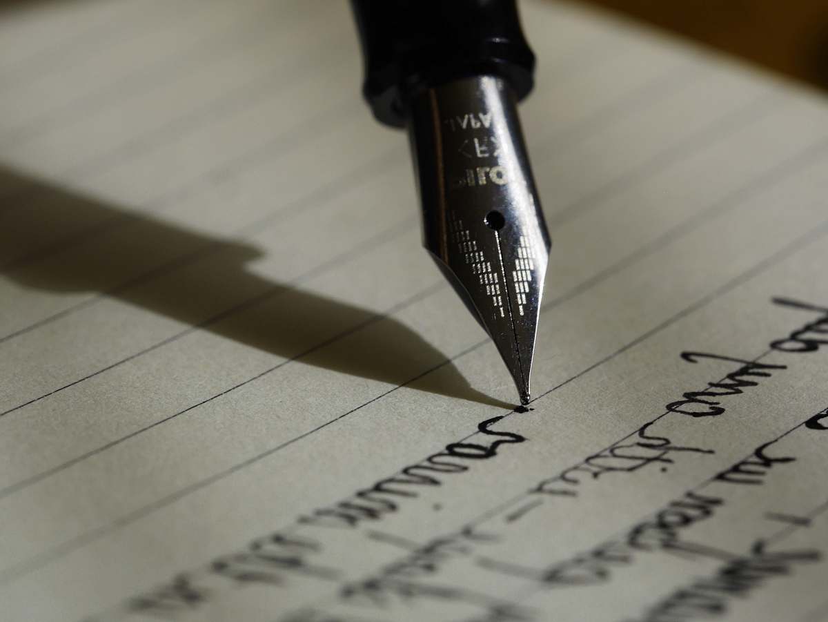 fountain pen fountain pen on black lined paper writing